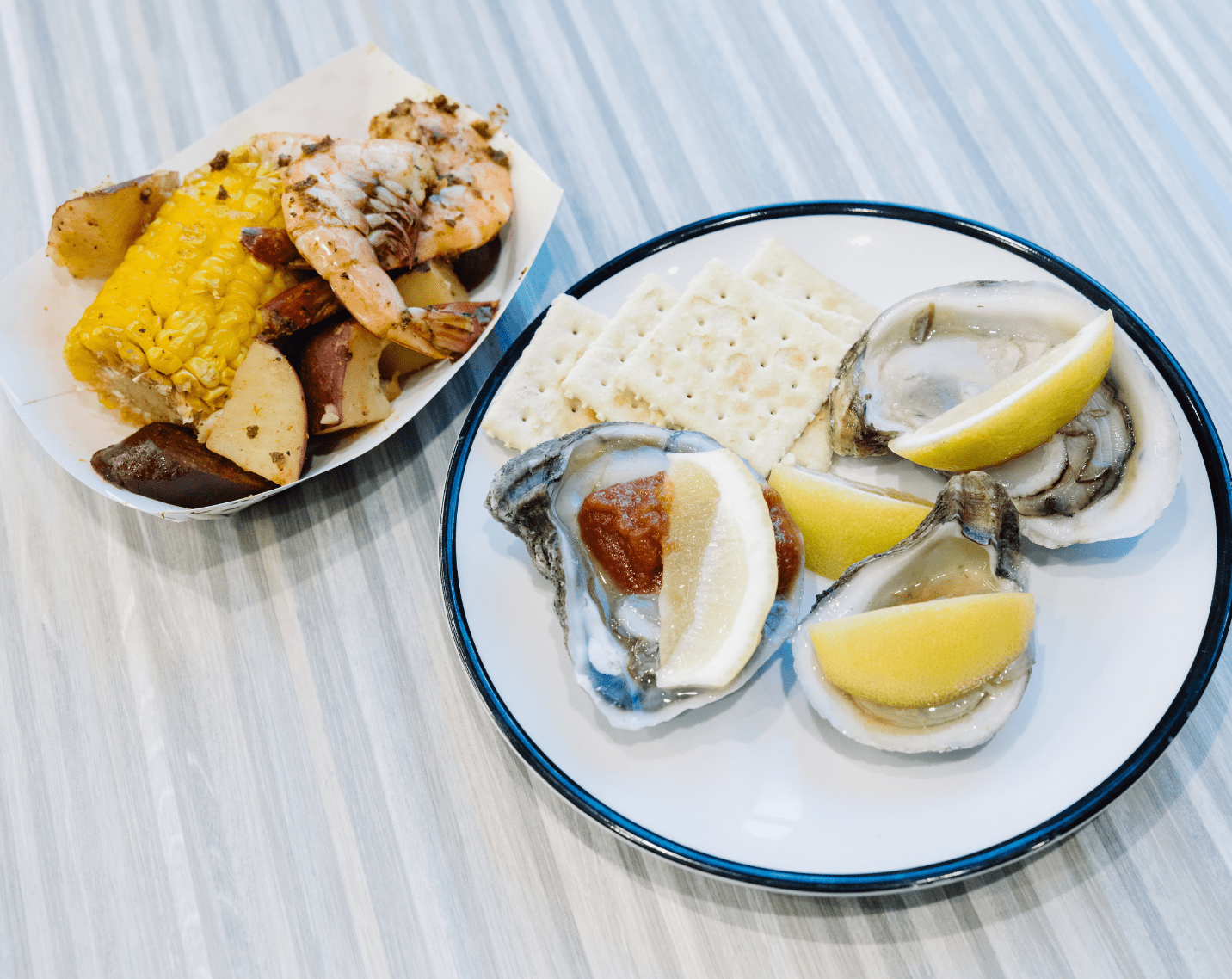 Lowcountry boil with corn, sausage, potatoes, and shrimp, along with oysters on the half shell.